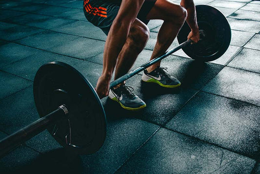 man deadlifting a barbell